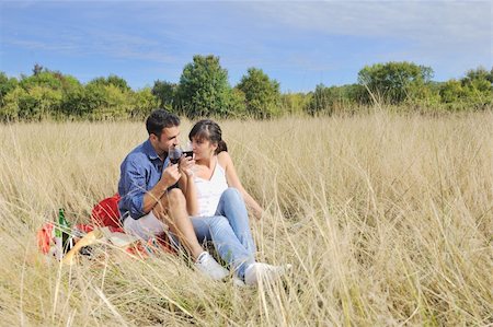 happy young couple enjoying  picnic on the countryside in the field  and have good time Stock Photo - Budget Royalty-Free & Subscription, Code: 400-05875219