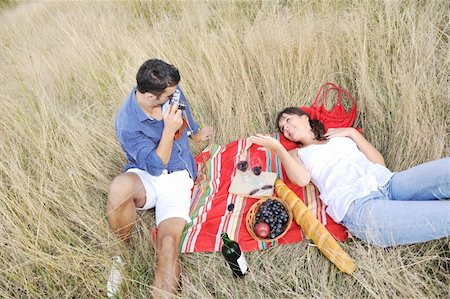 family picnic field - happy young couple enjoying  picnic on the countryside in the field  and have good time Stock Photo - Budget Royalty-Free & Subscription, Code: 400-05875213