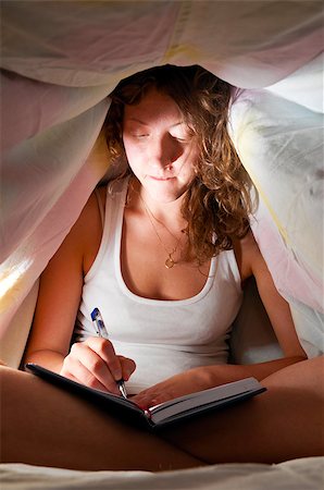 woman is sitting under cover in bed and writing her diary Stock Photo - Budget Royalty-Free & Subscription, Code: 400-05875455