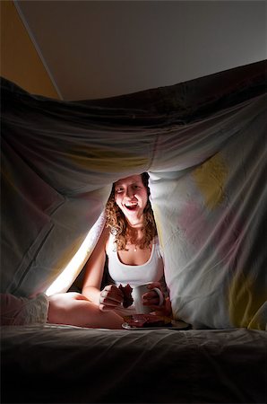 woman is sitting under cover in bed and eating Stock Photo - Budget Royalty-Free & Subscription, Code: 400-05875456