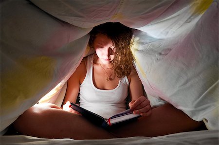 woman is reading under cover in bed and writing her diary Stock Photo - Budget Royalty-Free & Subscription, Code: 400-05875467