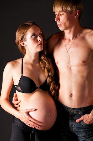 skinny man long hair - pregnant woman and her man on black background Stock Photo - Budget Royalty-Free & Subscription, Code: 400-05875641