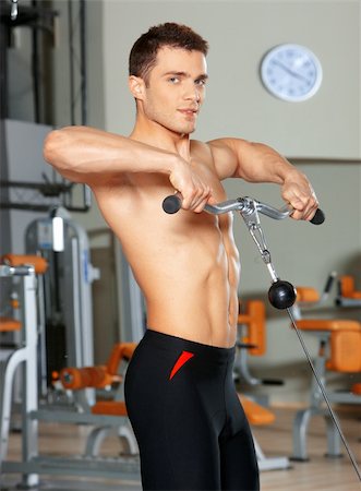 simsearch:400-05910572,k - Handsome man at the gym doing exercises Fotografie stock - Microstock e Abbonamento, Codice: 400-05875753