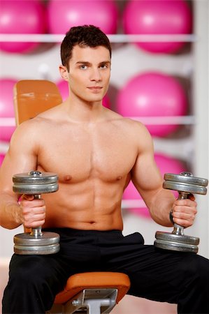 simsearch:400-05910572,k - Handsome man at the gym doing exercises Fotografie stock - Microstock e Abbonamento, Codice: 400-05875768