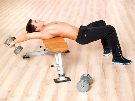 simsearch:400-05910572,k - Handsome man at the gym doing exercises Fotografie stock - Microstock e Abbonamento, Codice: 400-05875774