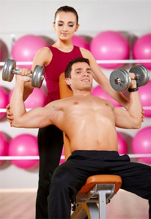 simsearch:400-05875765,k - Sporty couple exercising at the fitness gym Stock Photo - Budget Royalty-Free & Subscription, Code: 400-05875771