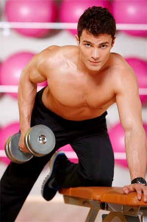 simsearch:400-05910572,k - Handsome man at the gym doing exercises Fotografie stock - Microstock e Abbonamento, Codice: 400-05875773