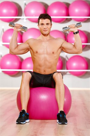 simsearch:400-05910572,k - Handsome man at the gym doing exercises Fotografie stock - Microstock e Abbonamento, Codice: 400-05875791