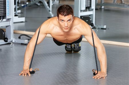 simsearch:400-05910572,k - Handsome man at the gym doing exercises Fotografie stock - Microstock e Abbonamento, Codice: 400-05875800