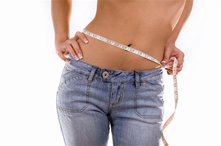 woman measuring her waist wearing blue jeans Stock Photo - Budget Royalty-Free & Subscription, Code: 400-05875928