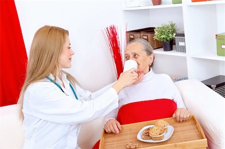 Young nurse helping elderly woman to drink Stock Photo - Budget Royalty-Free & Subscription, Code: 400-05876351