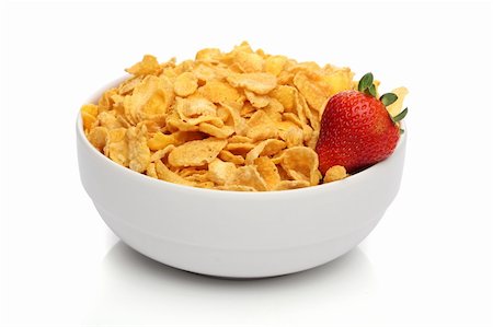 Pile of cornflakes on a bowl over white background Stock Photo - Budget Royalty-Free & Subscription, Code: 400-05876762