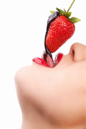 Beautiful girl eating a fresh red strawberry with chocolate sauce Stock Photo - Budget Royalty-Free & Subscription, Code: 400-05876943