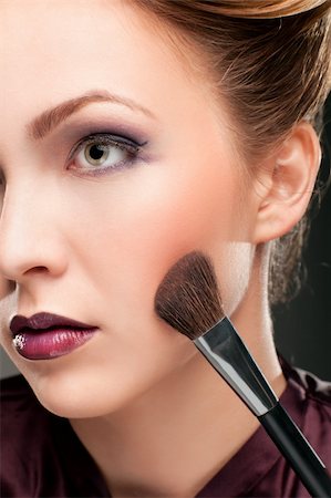 Portrait of beautiful woman with makeup brushes - isolated on white Stock Photo - Budget Royalty-Free & Subscription, Code: 400-05877312