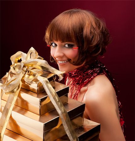 simsearch:400-06083238,k - Beautiful girl with a gift, over on red background Stock Photo - Budget Royalty-Free & Subscription, Code: 400-05877554