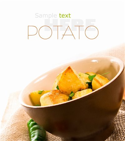 scrub country - Roasted potatoes with herbs over white background Stock Photo - Budget Royalty-Free & Subscription, Code: 400-05877757
