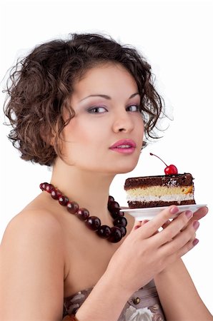 Attractive brunette woman with a cake looking in camera Stock Photo - Budget Royalty-Free & Subscription, Code: 400-05877834