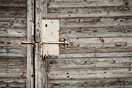 Old latch with padlock on doors Stock Photo - Budget Royalty-Free & Subscription, Code: 400-05878103