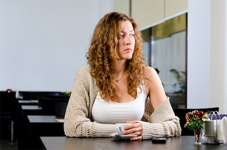 young woman is sitting at cafe and looking sideways Photographie de stock - Aubaine LD & Abonnement, Code: 400-05878569