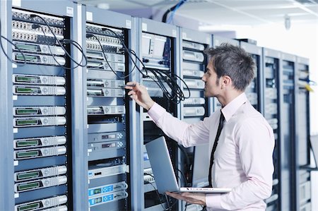 simsearch:400-05291409,k - young engeneer business man with thin modern aluminium laptop in network server room Stock Photo - Budget Royalty-Free & Subscription, Code: 400-05878615