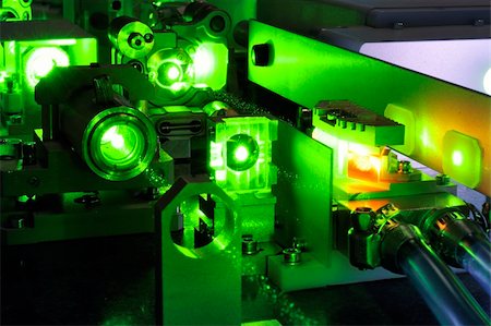 red laser beam - bright green laser light going inside complicate scientific system with cooling hoses inside Stock Photo - Budget Royalty-Free & Subscription, Code: 400-05878934