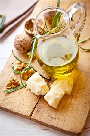 rosemary sprig - jug of olive oil, italian grana padano cheese and walnuts on wooden board Stock Photo - Budget Royalty-Free & Subscription, Code: 400-05878976
