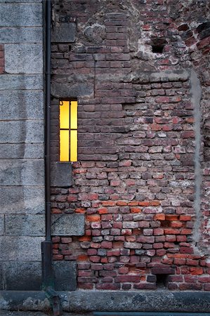 simsearch:400-05705183,k - Ancient brick wall with small lit window Stock Photo - Budget Royalty-Free & Subscription, Code: 400-05879008