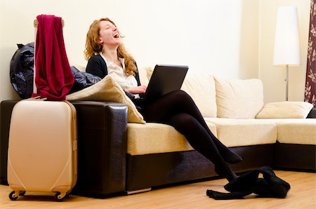 smiling woman is using laptop at hotel room Stock Photo - Budget Royalty-Free & Subscription, Code: 400-05879836