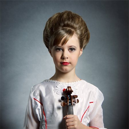 Symmetric portrait of beautiful young girl with violin posing on black background Stock Photo - Budget Royalty-Free & Subscription, Code: 400-05879841