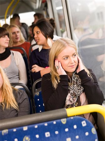 Woman listen to music while going by the bus Stock Photo - Budget Royalty-Free & Subscription, Code: 400-05884032
