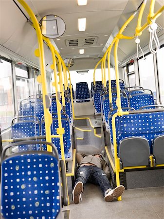 drunk asleep on the floor - Young man lieing on the floor on the bus Stock Photo - Budget Royalty-Free & Subscription, Code: 400-05884046