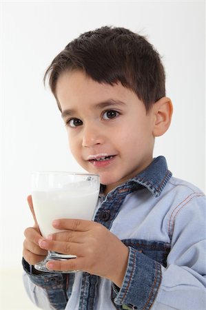 Handsome child drinking a glass of milk Stock Photo - Budget Royalty-Free & Subscription, Code: 400-05884570