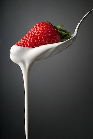simsearch:400-08251879,k - Whipped cream trickle from a silver spoon with a red strawberry Stock Photo - Budget Royalty-Free & Subscription, Code: 400-05884597