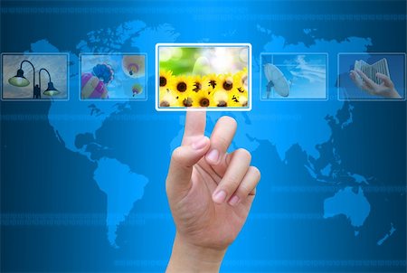 future earth icon - businessman hand pushing a button streaming images on a touch screen interface Stock Photo - Budget Royalty-Free & Subscription, Code: 400-05888649