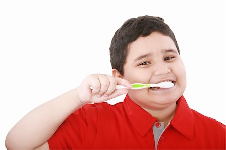 Beautiful boy brushing teeth, isolated on white Stock Photo - Budget Royalty-Free & Subscription, Code: 400-05889055