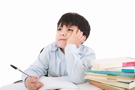 Upset schoolboy doing homework isolated on white Stock Photo - Budget Royalty-Free & Subscription, Code: 400-05889108