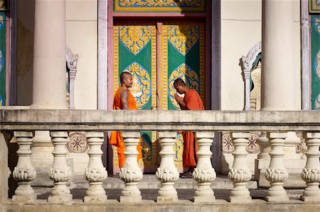 Two young buddhist monks meeting and saluting in a temple, Phnom, Penh, Cambodia, Asia. Side view Stock Photo - Budget Royalty-Free & Subscription, Code: 400-05889235