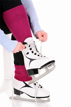 simsearch:400-04319654,k - A picture of a woman tying her skates over white background Stockbilder - Microstock & Abonnement, Bildnummer: 400-05889483