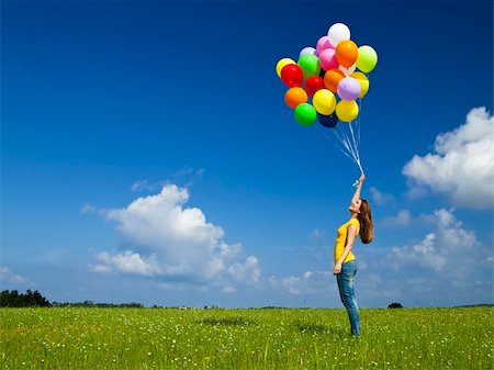 simsearch:400-06077546,k - Happy young woman with colorful balloons on a green meadow Stockbilder - Microstock & Abonnement, Bildnummer: 400-05889944