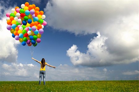 simsearch:400-08262183,k - Happy young woman with colorful balloons on a green meadow Stock Photo - Budget Royalty-Free & Subscription, Code: 400-05889942