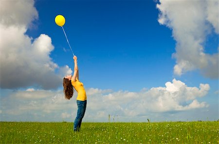 simsearch:400-06077546,k - Happy young woman with a yellow balloon on a green meadow Stockbilder - Microstock & Abonnement, Bildnummer: 400-05889943