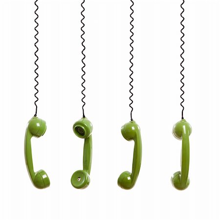 Handset piece from an old phone suspended by the phone cord, isolated on white background Stock Photo - Budget Royalty-Free & Subscription, Code: 400-05889999