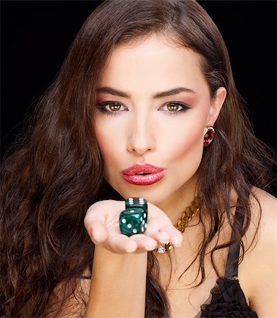 pretty young woman holding dices on black background Stockbilder - Microstock & Abonnement, Bildnummer: 400-05880184