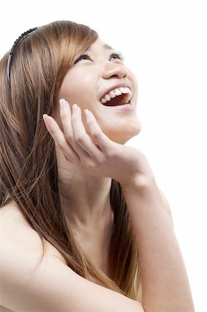 Laughing Asian woman looking up on white background Stock Photo - Budget Royalty-Free & Subscription, Code: 400-05880482