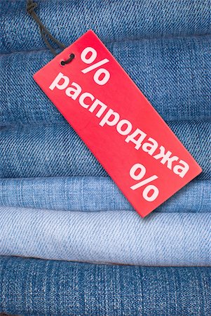simsearch:400-04758693,k - Red Russian Sale Sign With Stack of Blue Jeans in Background Photographie de stock - Aubaine LD & Abonnement, Code: 400-05880491