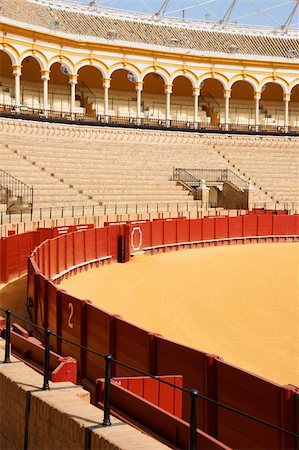 plaza de toros andalucia - Plaza de toros de la Real Maestranza de Caballeria de Sevilla or simply Plaza de Toros of Seville is the oldest bullring in Spain. It was built in stone and wood beetween 1749 and 1881. In this place, every year takes place the famous Feria de Abril. Stock Photo - Budget Royalty-Free & Subscription, Code: 400-05880639