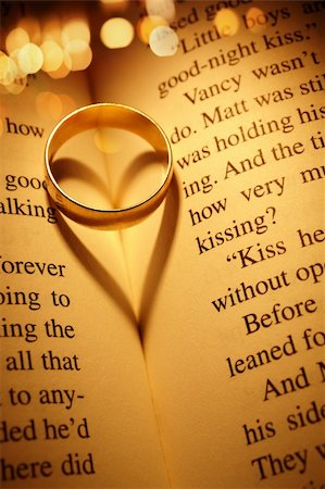 wedding ring inside a romance novel creates a shadow the shape of a heart ,and light f/x Stock Photo - Budget Royalty-Free & Subscription, Code: 400-05880800