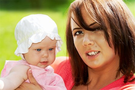 simsearch:400-08787277,k - Happy young mother with a little baby in a meadow Stock Photo - Budget Royalty-Free & Subscription, Code: 400-05881190