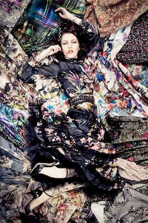 simsearch:400-04346129,k - Woman lying on a pieces of colorful fabrics Stock Photo - Budget Royalty-Free & Subscription, Code: 400-05881479