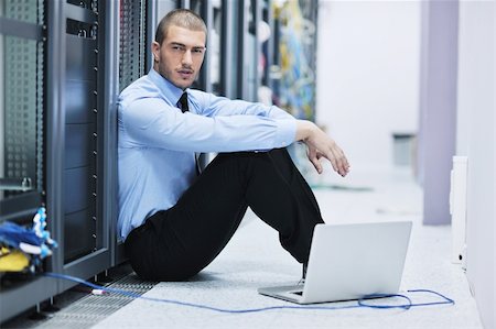 simsearch:400-04811186,k - young engeneer business man with thin modern aluminium laptop in network server room Stock Photo - Budget Royalty-Free & Subscription, Code: 400-05881503